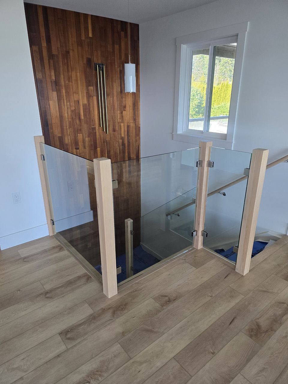 Glass stair railing, wood posts, North Nanaimo · February 2026